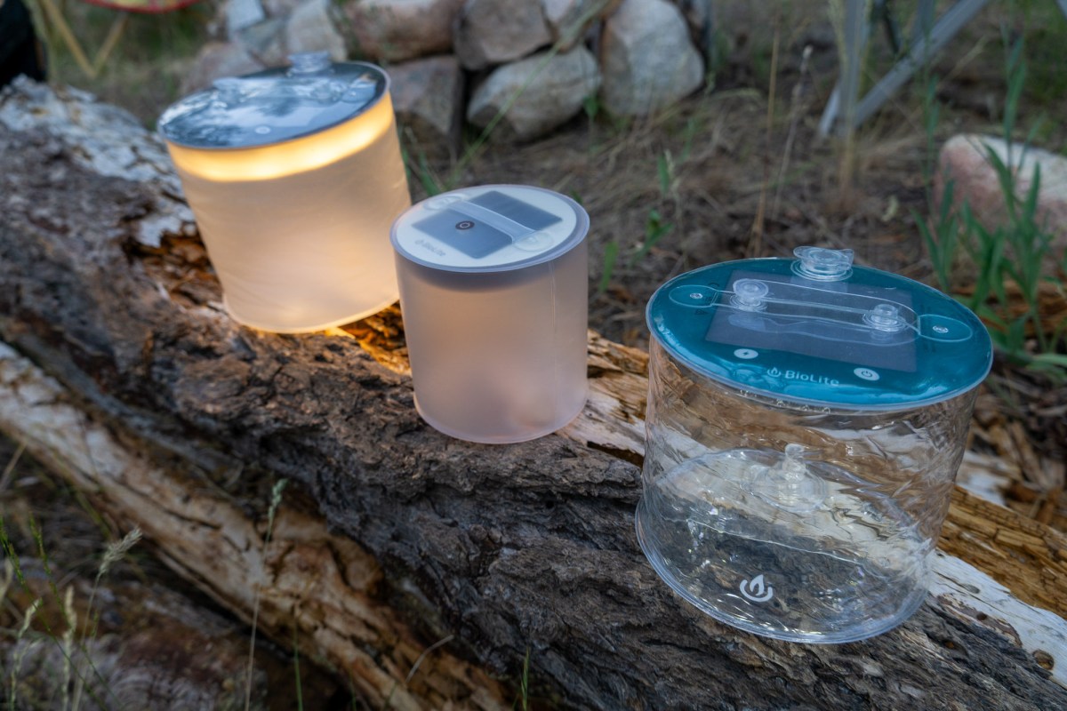 a trio of biolite luci lanterns set up on a log during a camping overnight on the san juan islands in washington state