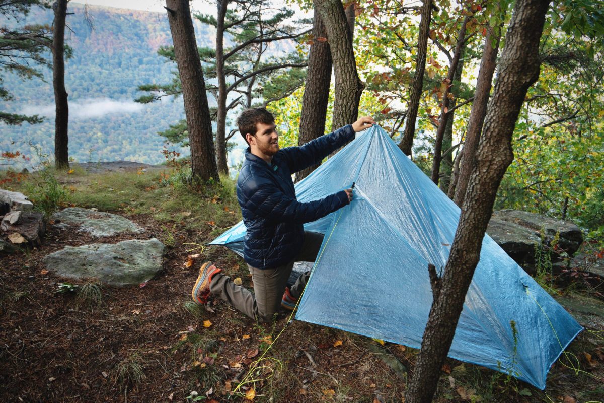 a gearjunkie tester sets up a non-freestanding trekking pole shelter, the zpacks altaplex