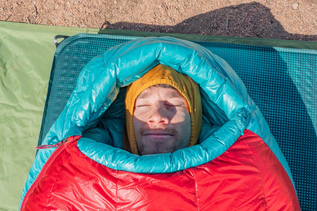 gearjunkie tester austin beck-doss tucks into the hood of the mountain hardware phantom sleeping bag