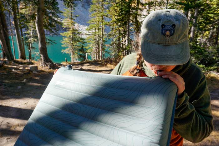 gearjunkie tester blowing up a therm-a-rest sleeping pad in the backcountry of washington state