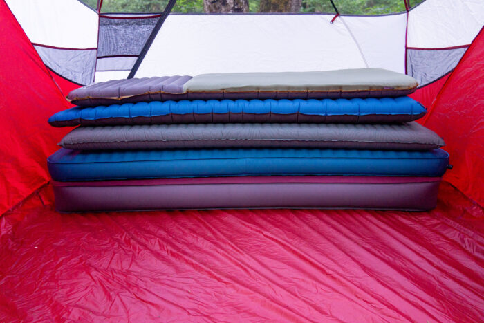 multiple camping mattresses stacked in an msr camping tent in washington state during gearjunkie testing
