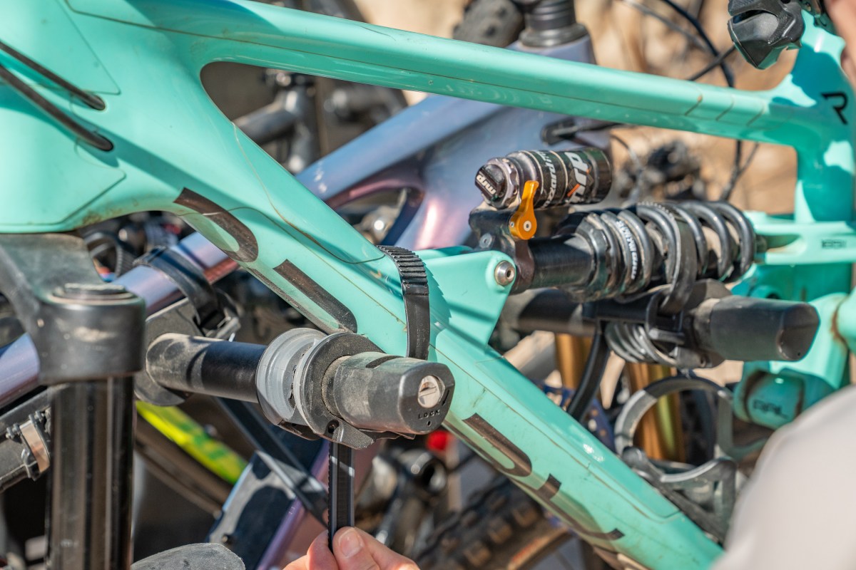 Ratchet straps are often used to hold bikes on hanging racks, but frame contact is a concern; (photos/Eric Phillips)