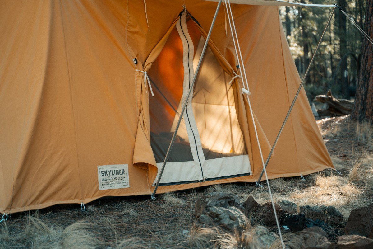 Springbar Skyliner tent doorway with mesh panels, tied back canvas, and front awning poles