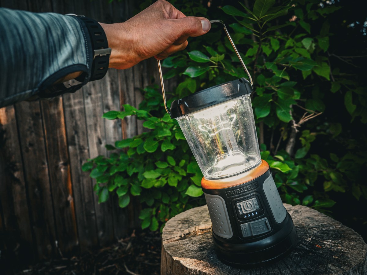 The Duracell 2000 Lumen Tri-Power Lantern lighted up on a stump in colorado