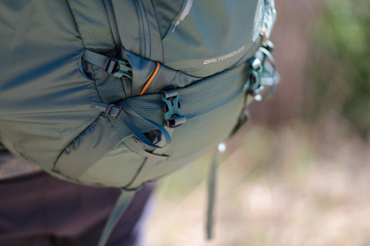 A close view of the Gregory Baltoro 65 backpack front buckles and compression straps