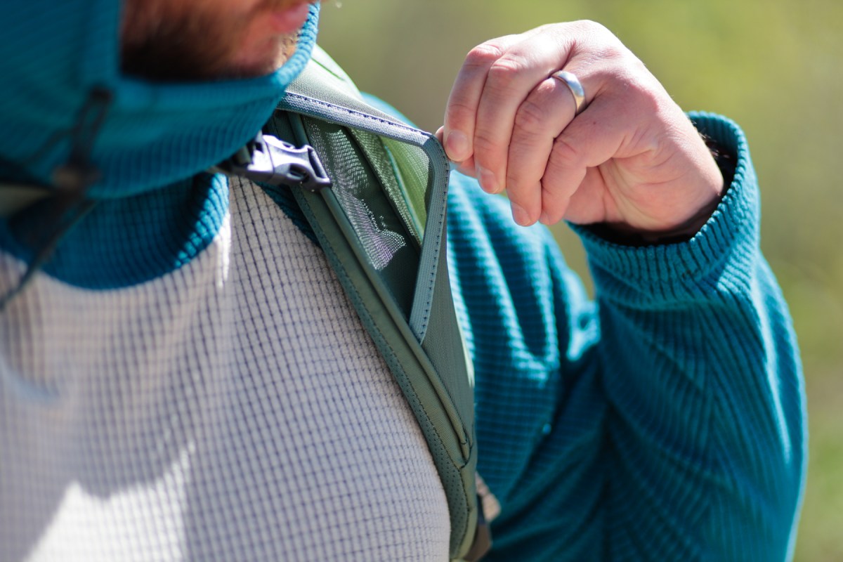 A close view of the Gregory Baltoro backpack shoulder strap pocket being opened