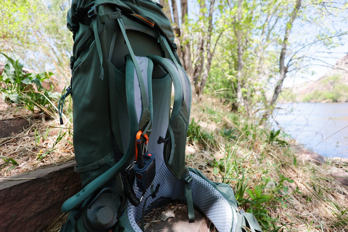 The Gregory Baltoro backpack rests near the water with its back panel, shoulder straps, and hip belt visible
