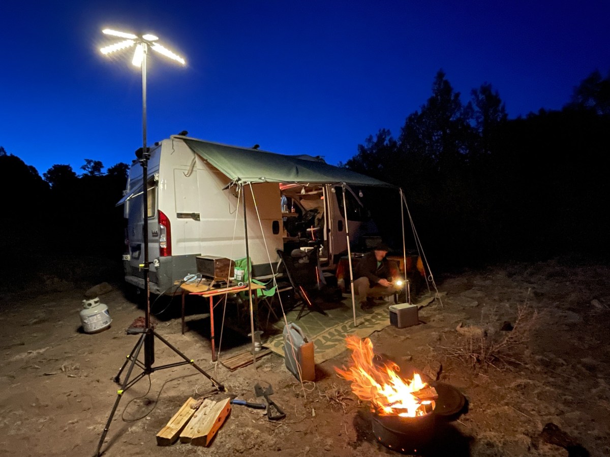 the goal zero skylight lantern set up at a van camp and casting light across the entire scene