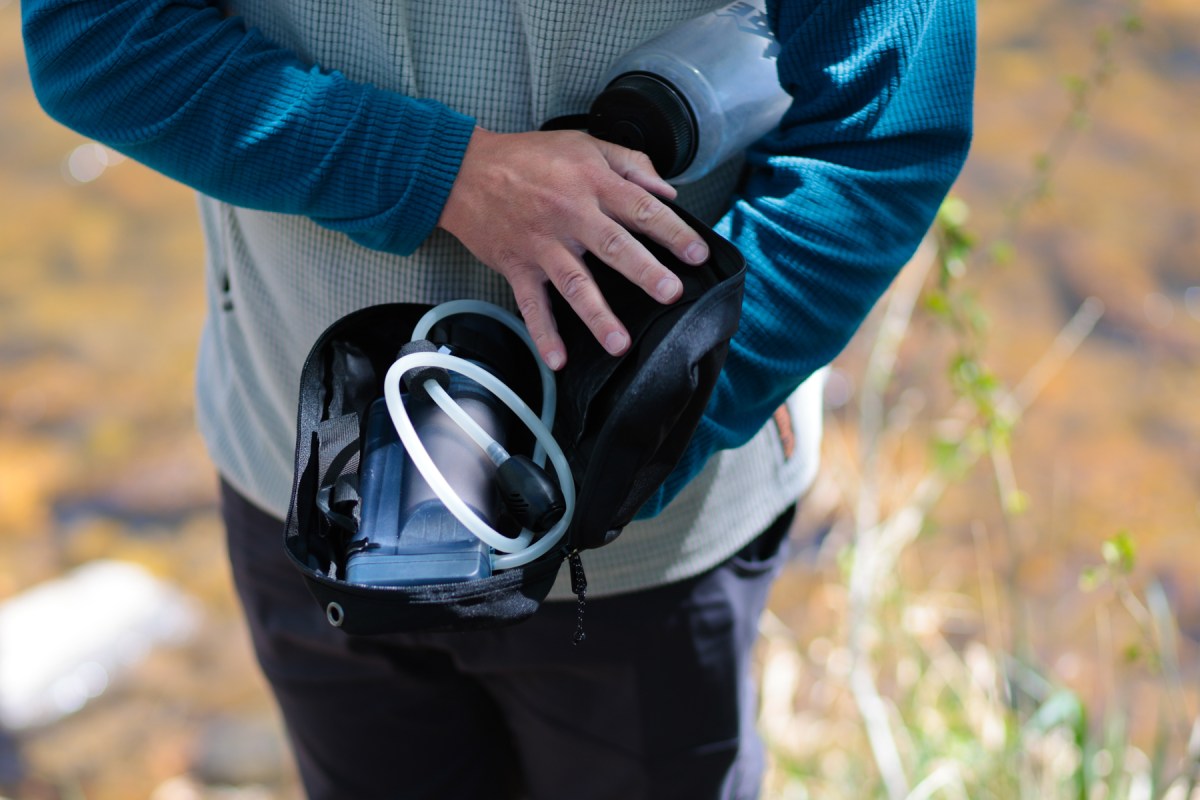 The pump purifier, bottle, and tubing packed inside a black carrying case