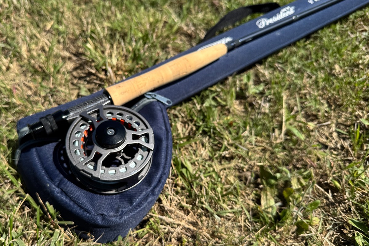 reel and cork handle lying on the rod case in the grass