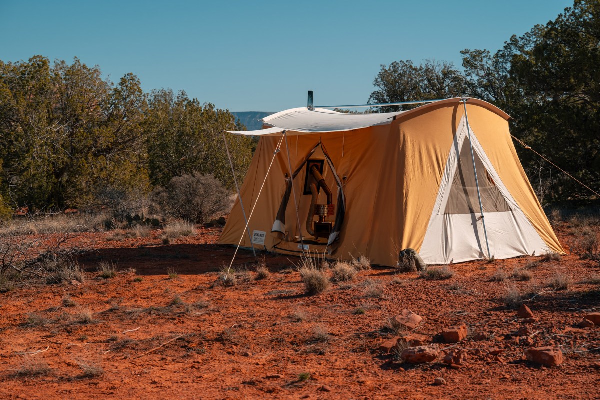 Springbar Skyliner hot tent set up on red dirt with the stove visible through the doorway