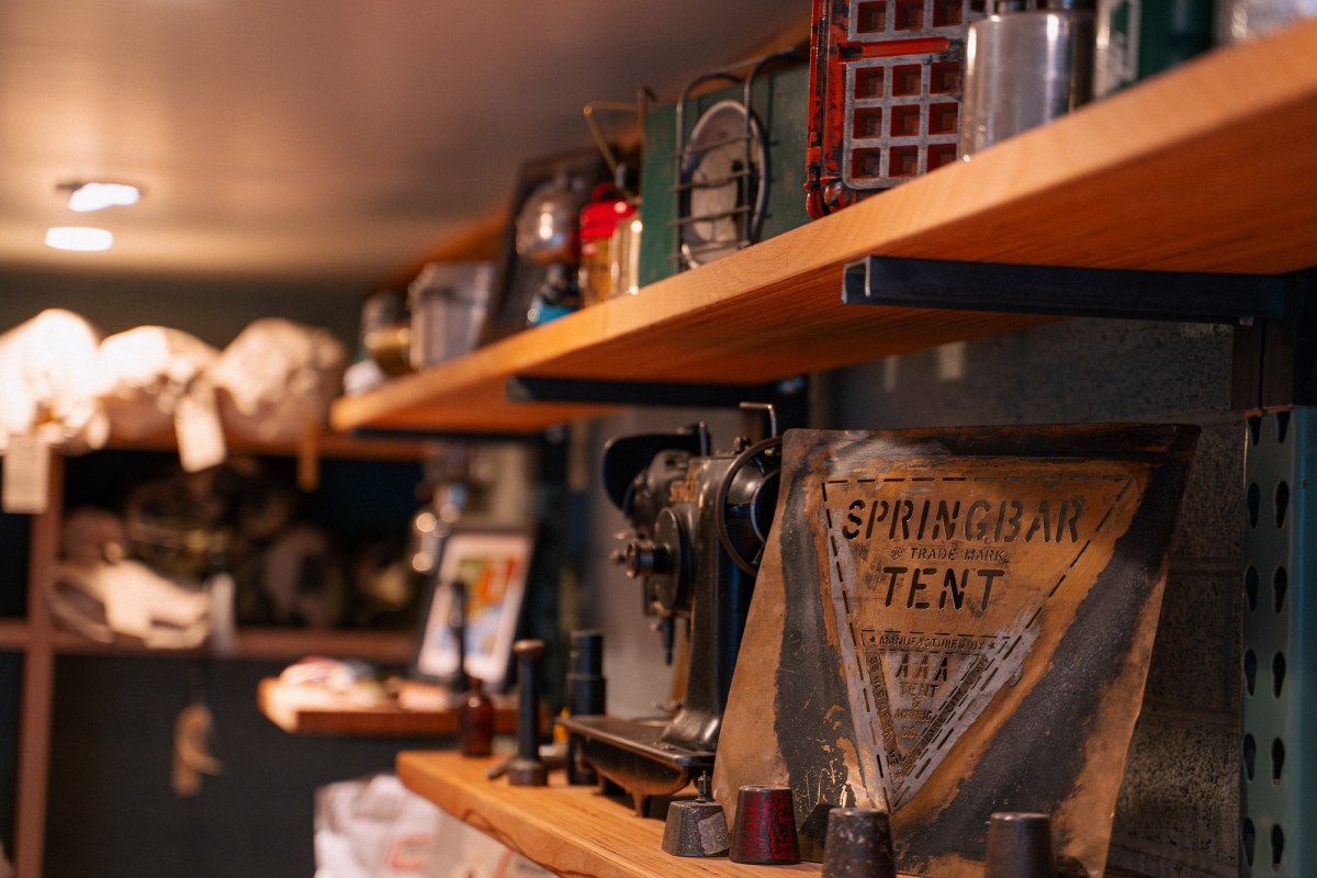 Vintage Springbar tent sign and sewing tools displayed on workshop shelve