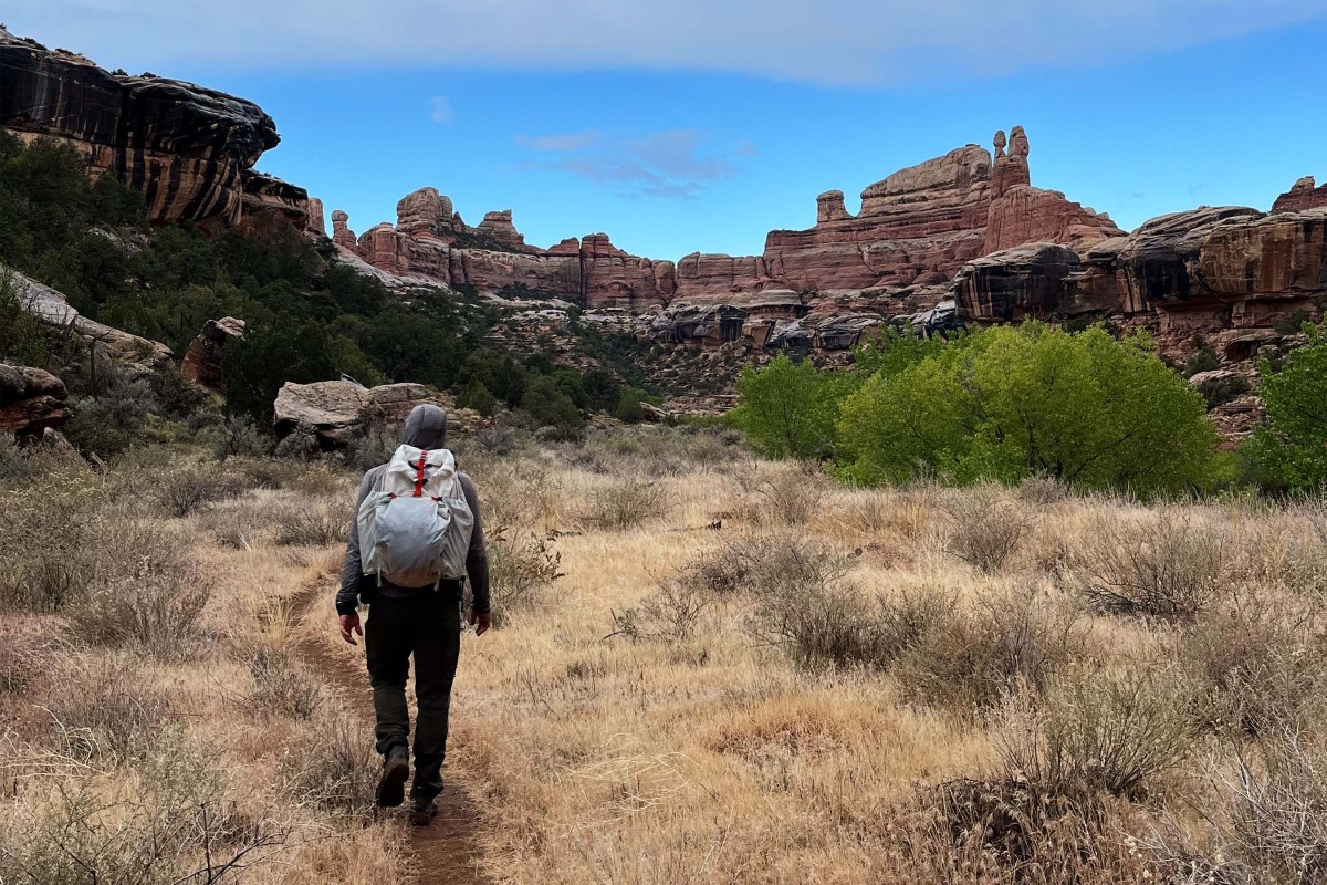 Man hiking with Mountain Hardwear Alakazam Backpack