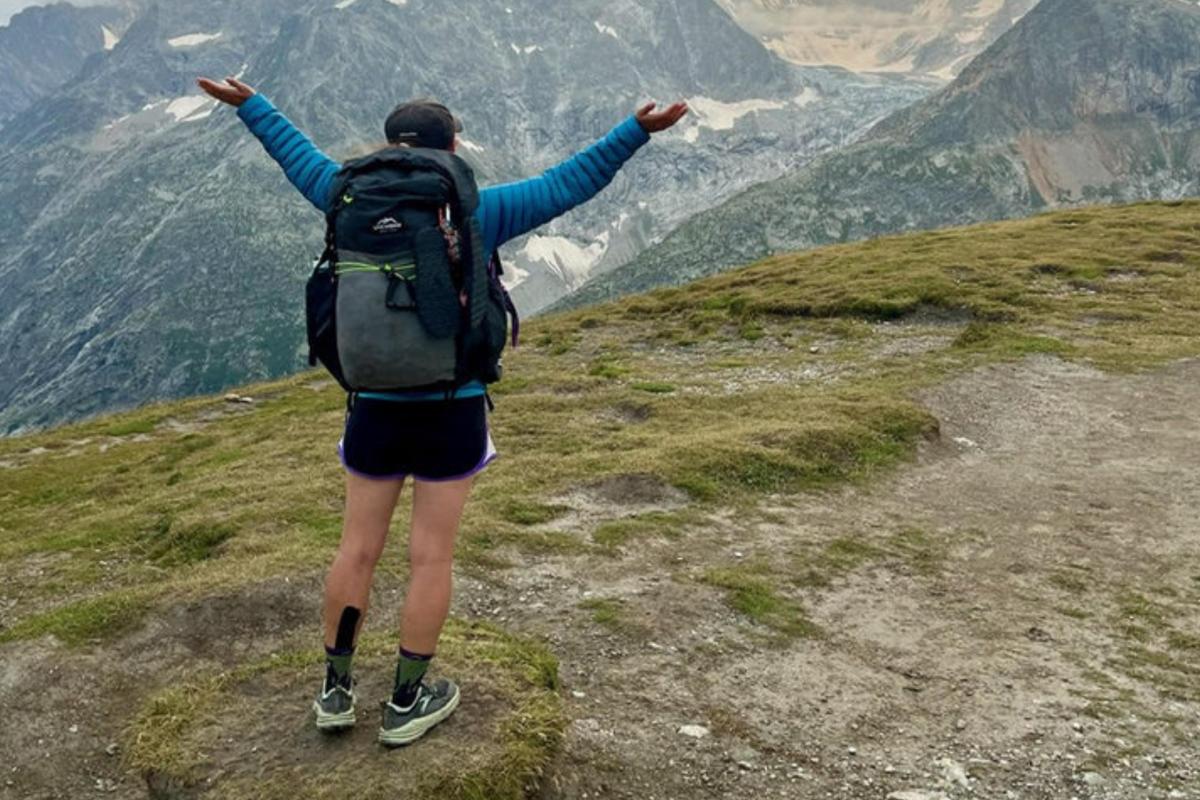 backpacker with their arms up 