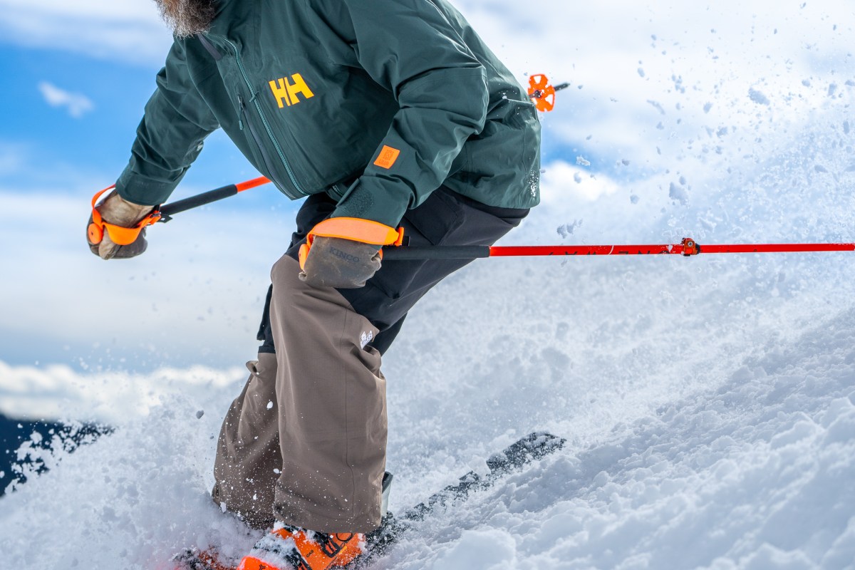 Close up of the HH Ridge Infinity Jacket 2.0 while skiing through deep snow
