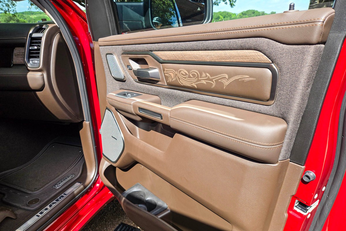 Ram Longhorn interior door panel with leather, wood, fabric, and western-style stitching