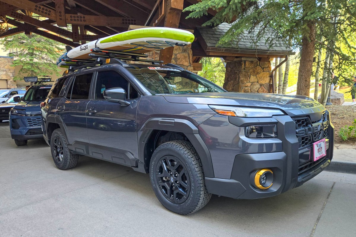 Gray Subaru Outback Wilderness with paddleboards mounted on the roof