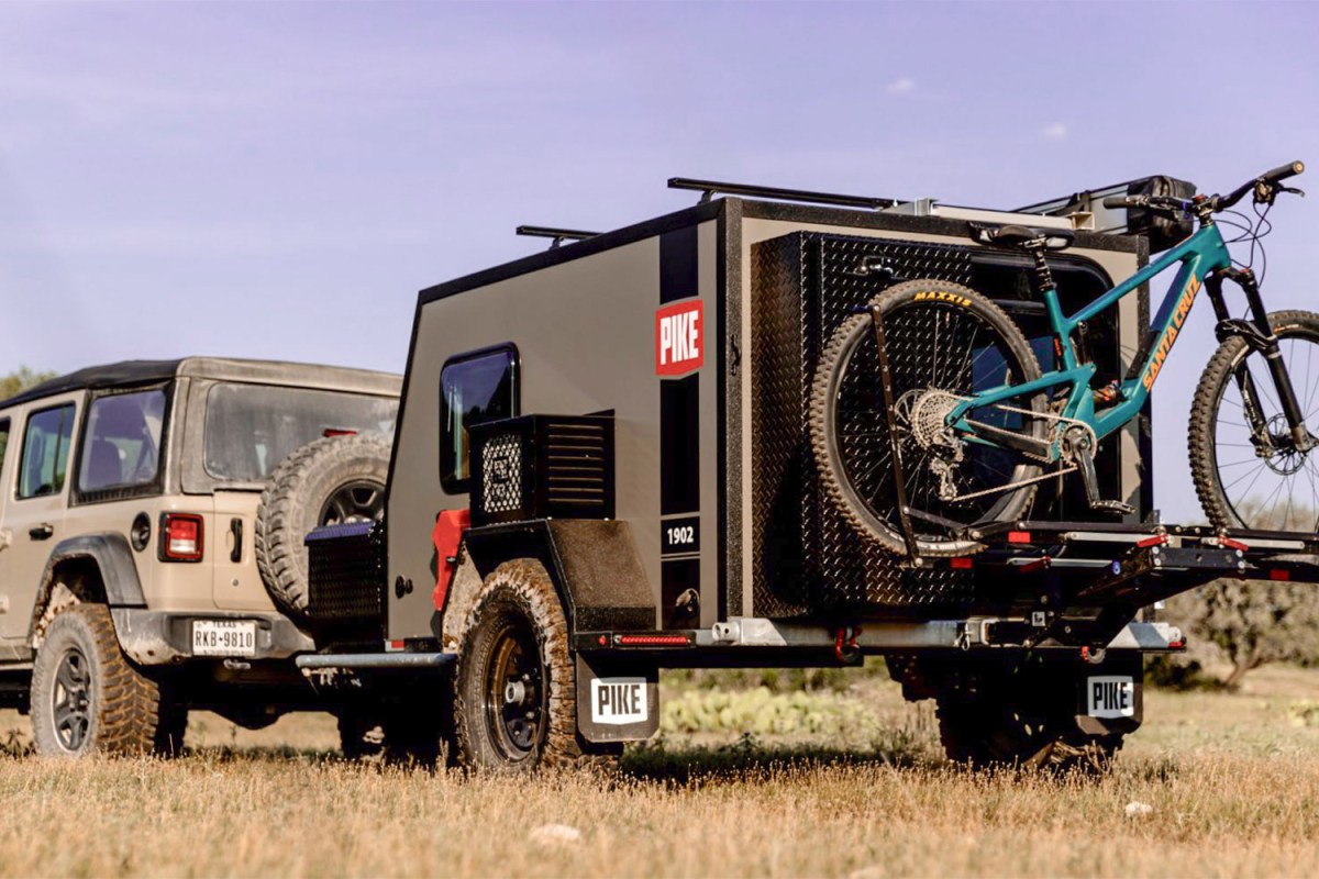 Pike 1902 trailer towed by a Jeep with a mountain bike mounted on the rear