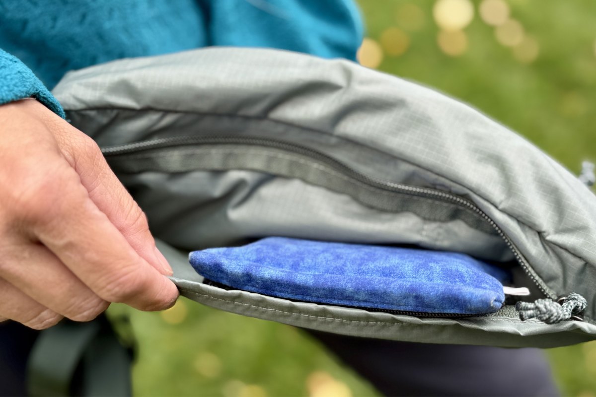 zipping up the REI Co op Trail 2 Waist Pack