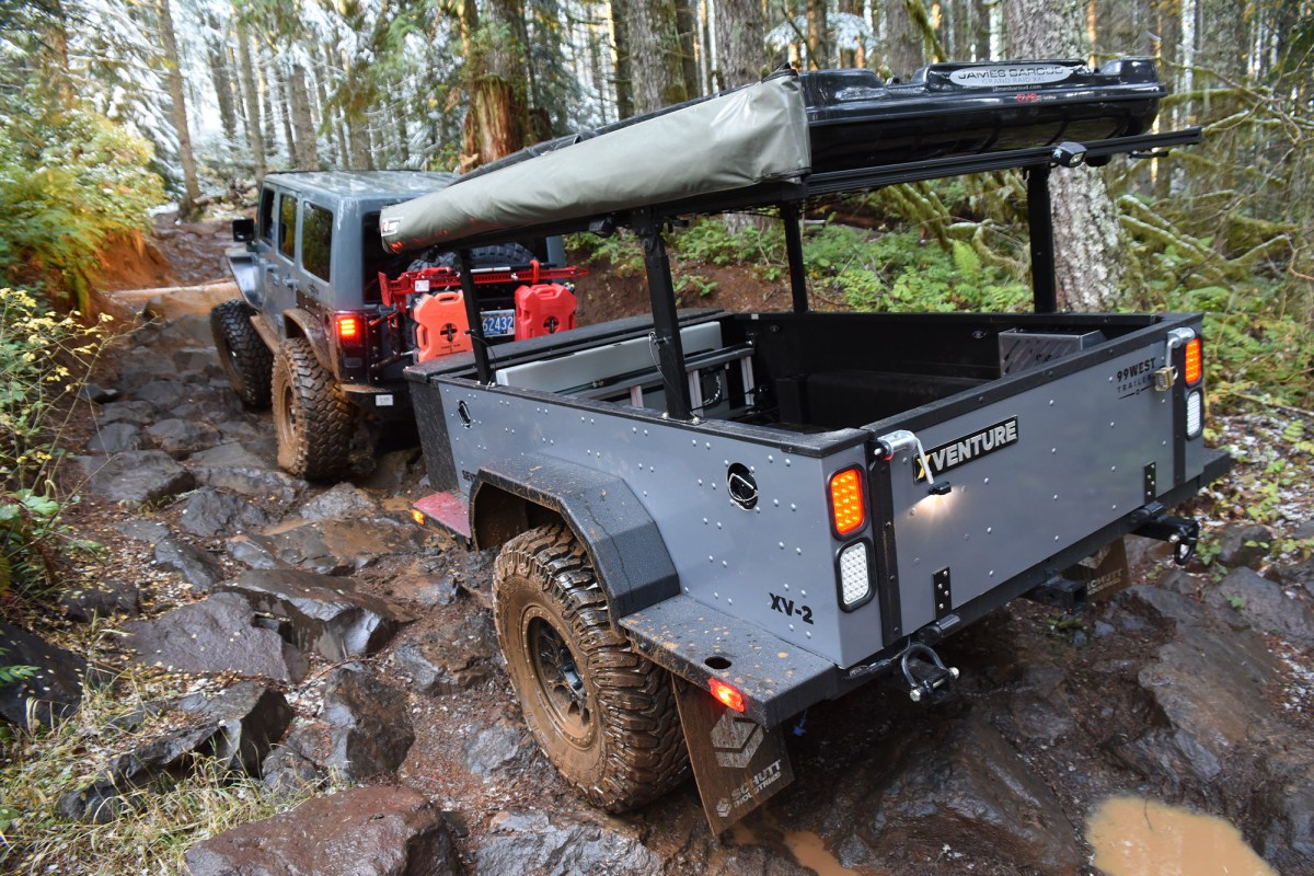 Schutt XV-2 trailer being pulled by a Jeep through a rocky forest trail