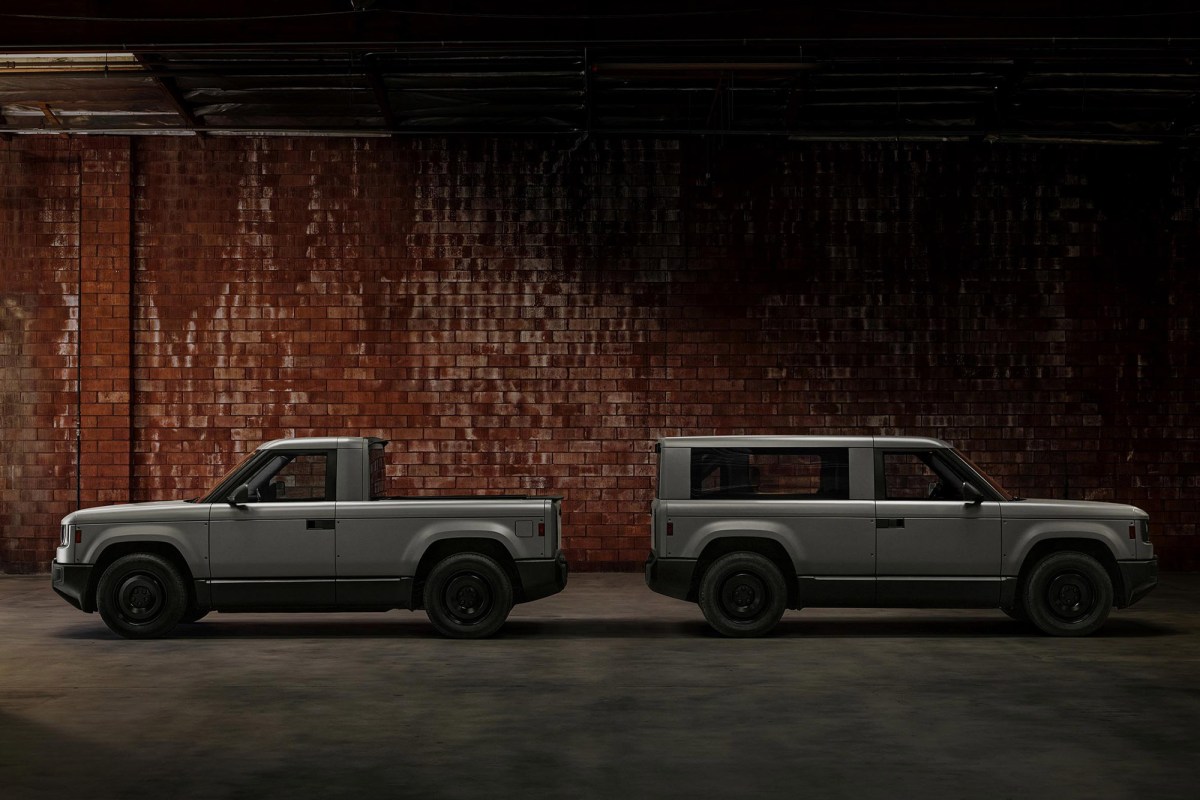Slate pickup and SUV shown in side profile against a brick warehouse wall