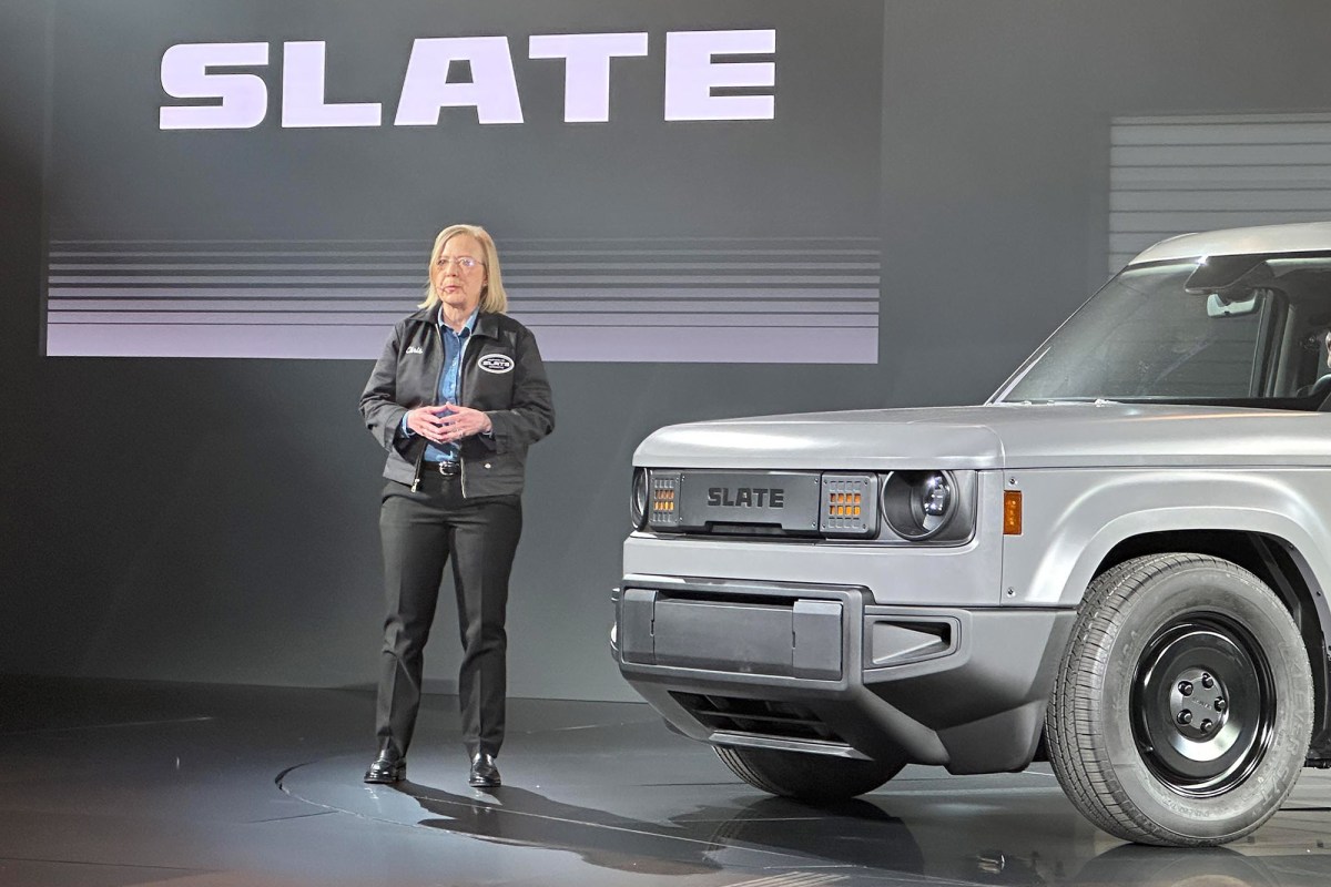 Speaker standing beside a Slate pickup during a launch presentation