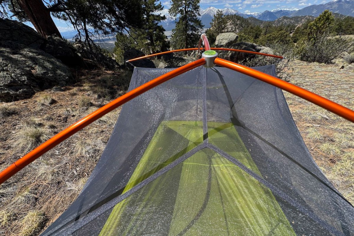 Orange tent poles connected over the Tiger Wall UL2 mesh body at a mountain campsite