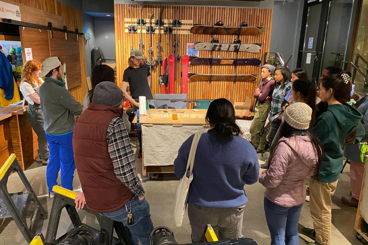 group of people stand out for a ski demo in a shop