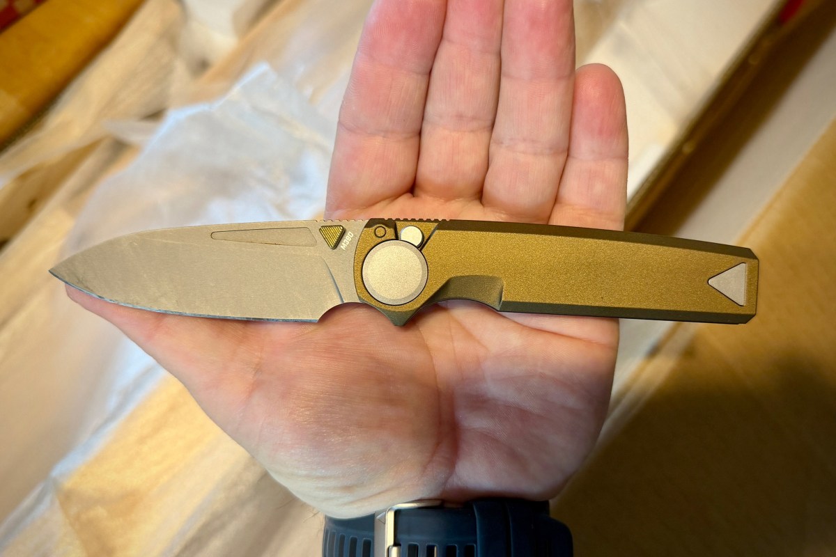 RMX Thumbstud knife shown open across a hand for size reference