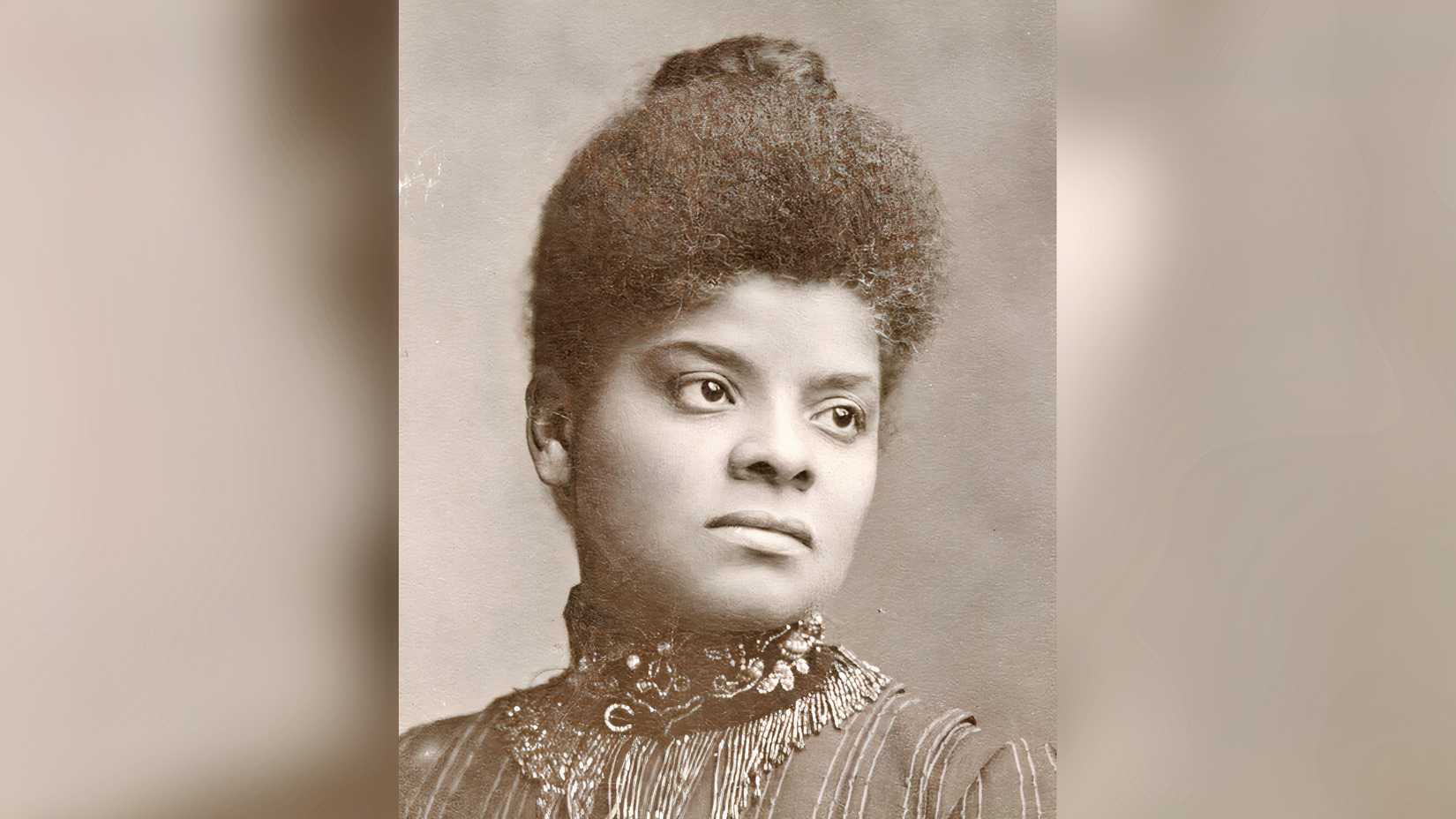 A black-and-white portrait of Ida B. Wells wearing a high-collared dress.