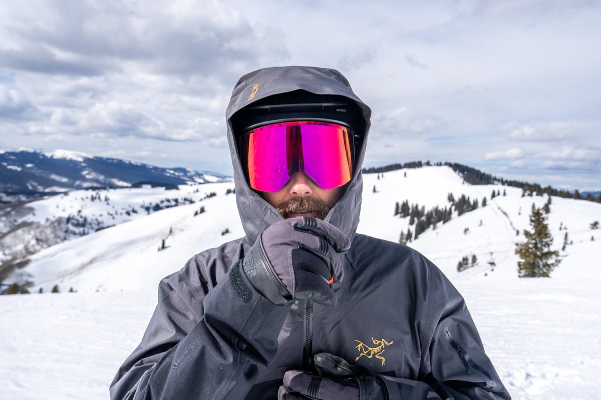 Close up of a skier in Arc'teryx Rush jacket hood fully zipped up, covering the face