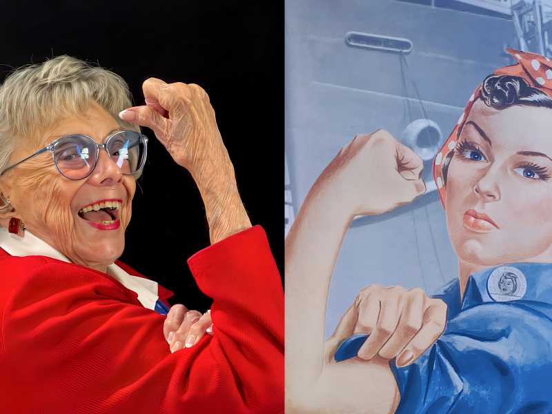 World War II Marine veteran and Rosie the Riveter Roberta “Randy” Tidmore poses beside a Rosie the Riveter poster.