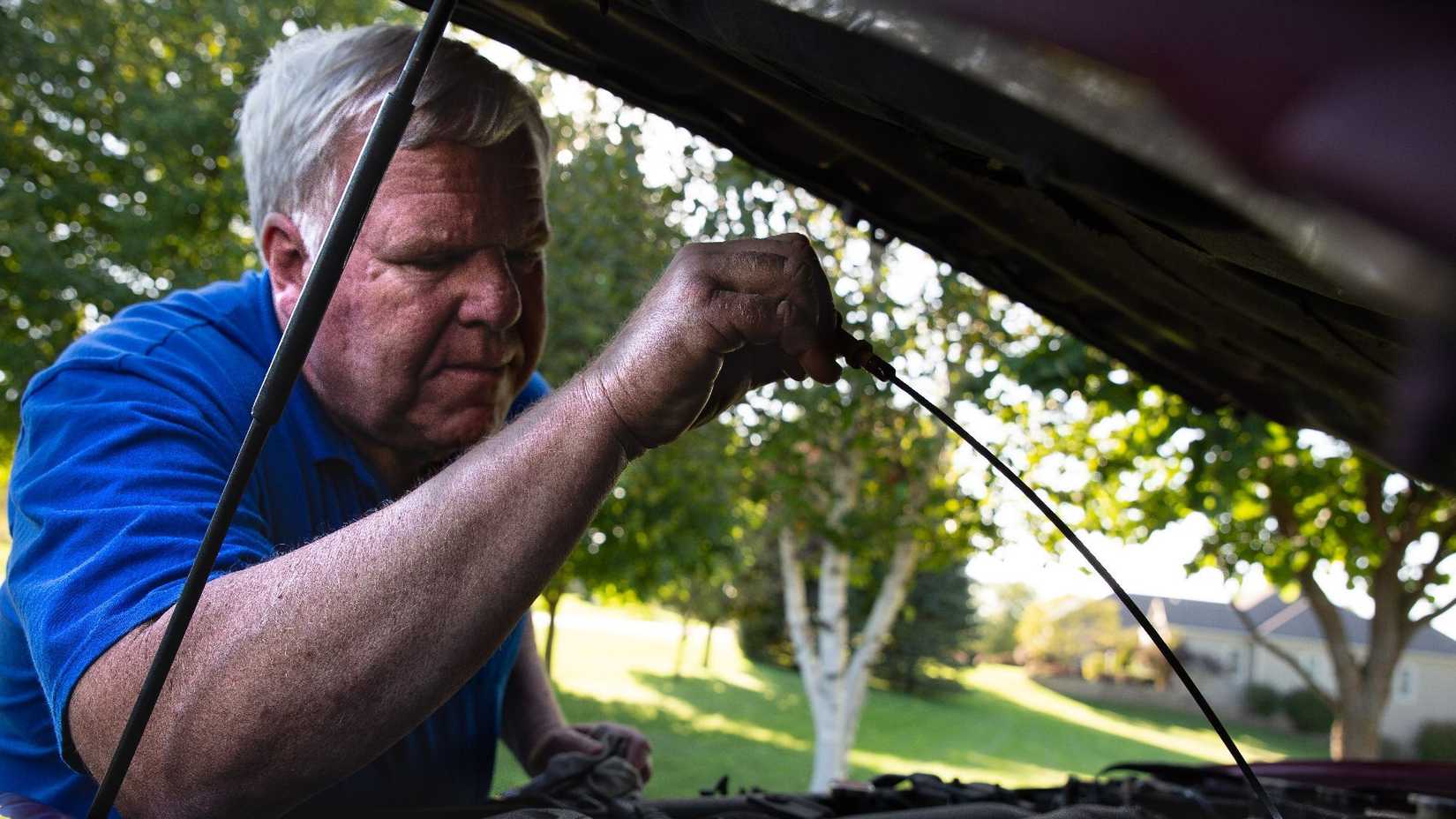 2007 Million Mile Nissan Frontier with its owner checking the oil