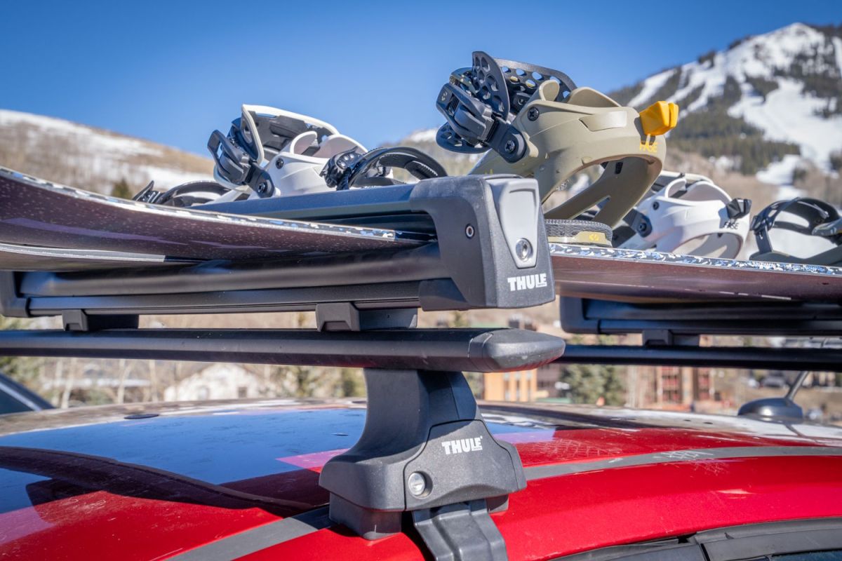 Thule Snowpack ski rack mounted on Thule crossbars holding multiple snowboards on car roof