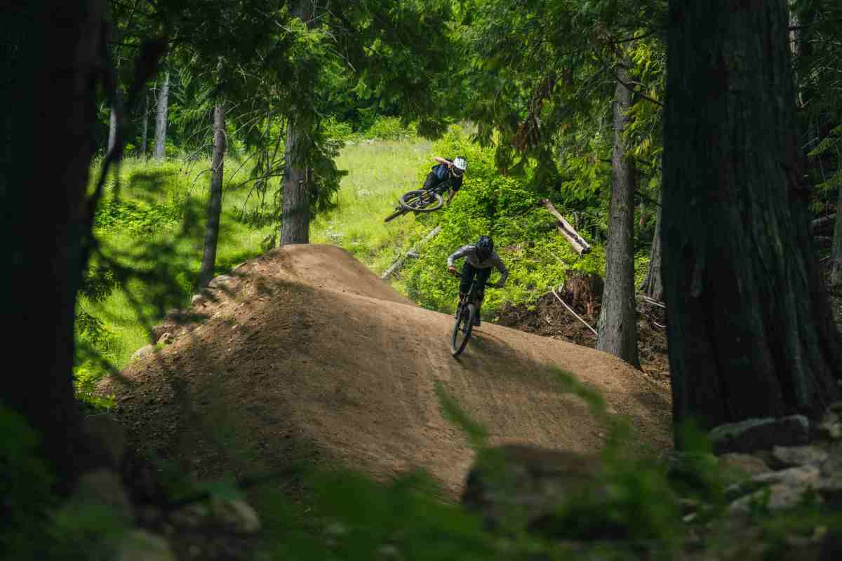 GL trail designer and manager Dane Tudor (foreground) and Sweet Protection ambassador Max Nutini (background) test riding the 30-foot shark fin on upper Obsidius at RED Bike Park; photo/Ashley Voykin