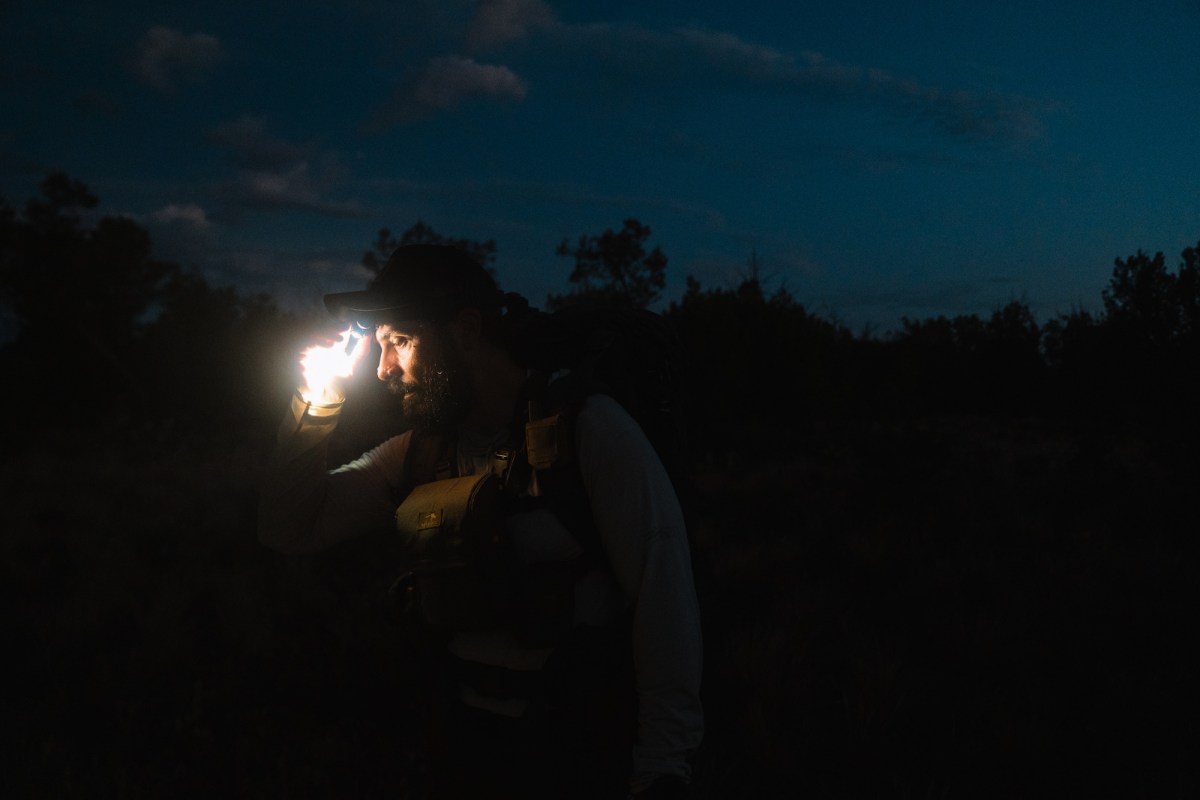 a man using the Dark Energy Oracle Headlamp at night