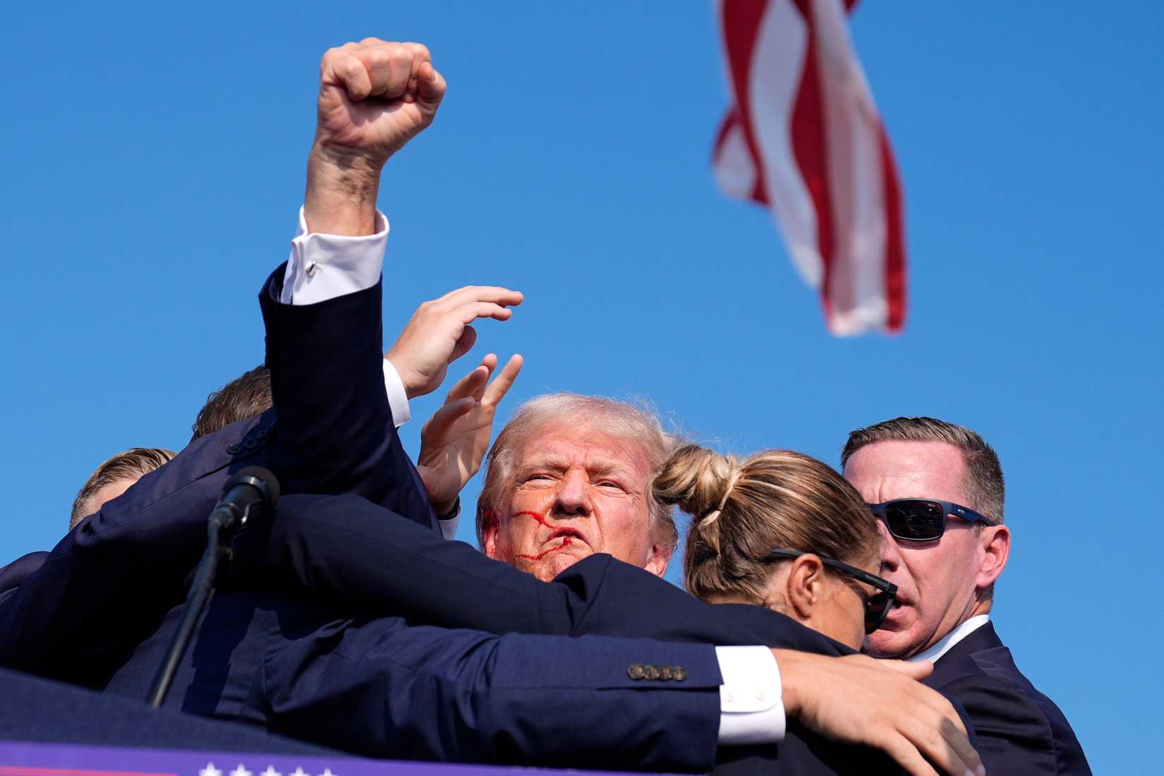 Secret Service whisks former President Donald Trump off stage.