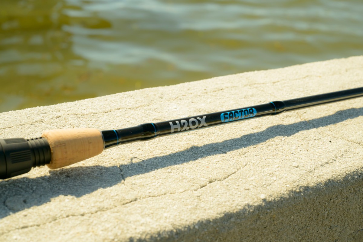 The blank of a fishing rod on a concrete wall.