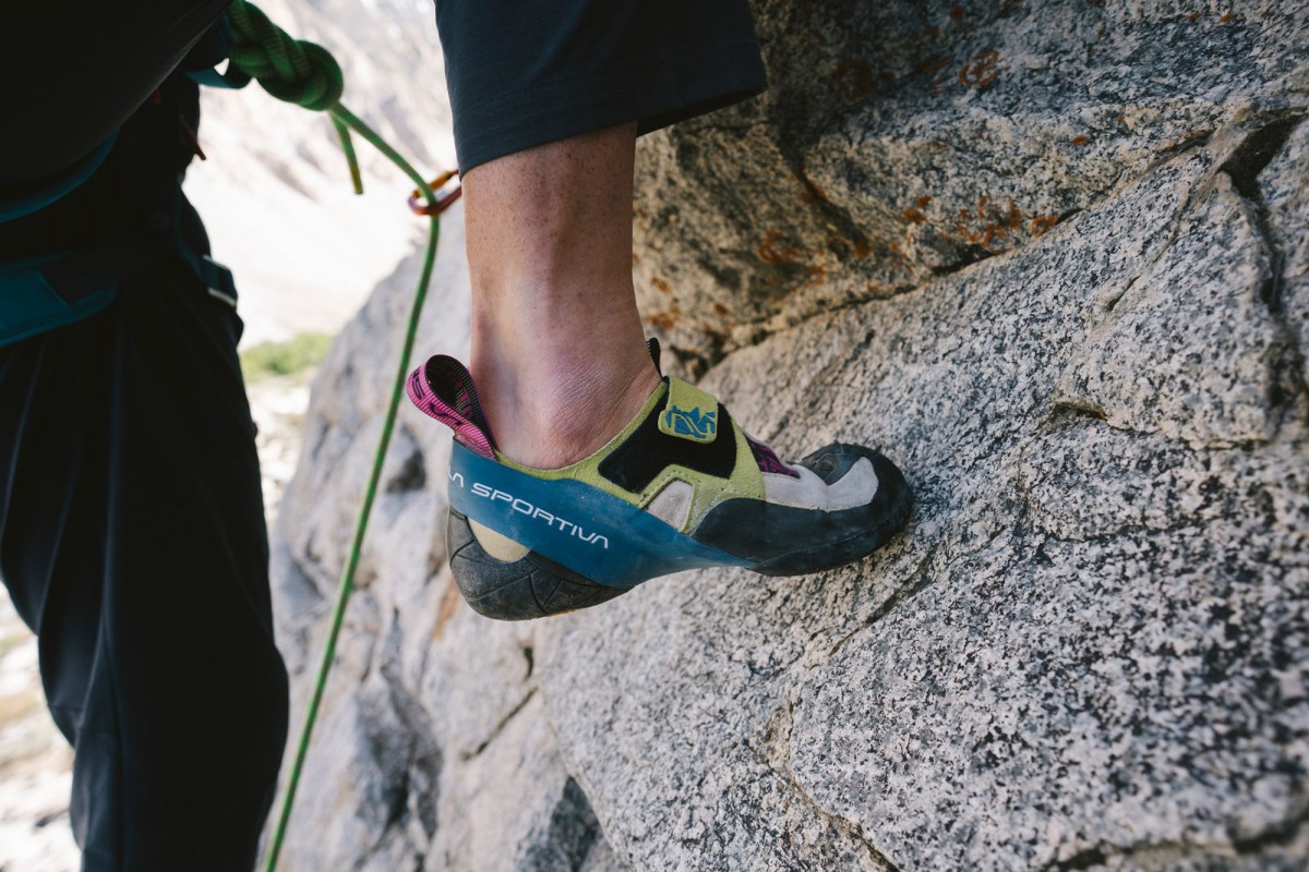Close-up of La Sportiva Skwama climbing shoes pressing on a small granite foothold during a climb