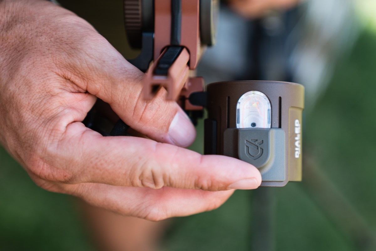hand holding the Dialed Archery Pruf 5-Pin Bow Sight