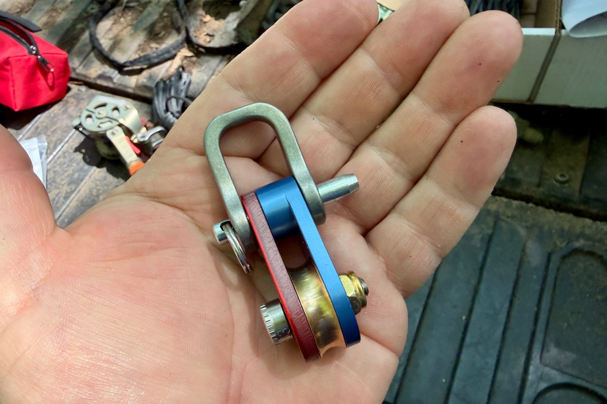 Close-up of the compact winch hardware held in a hand