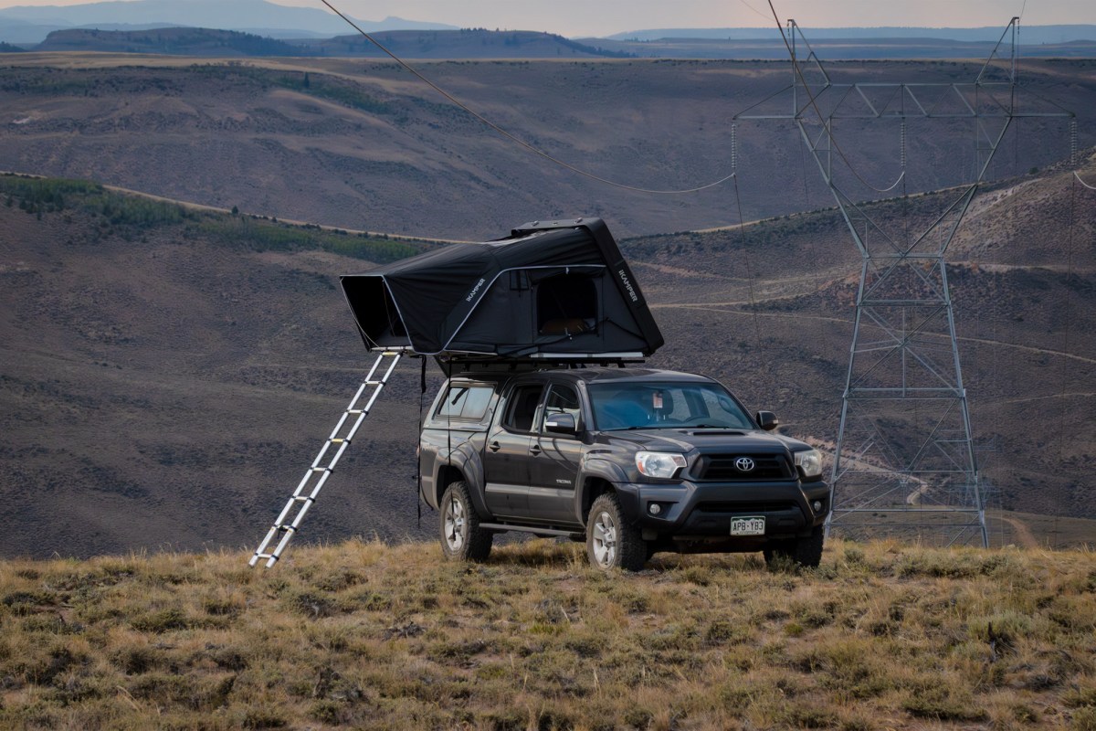 iKamper rooftop camper set up on a truck in mountainous terrain