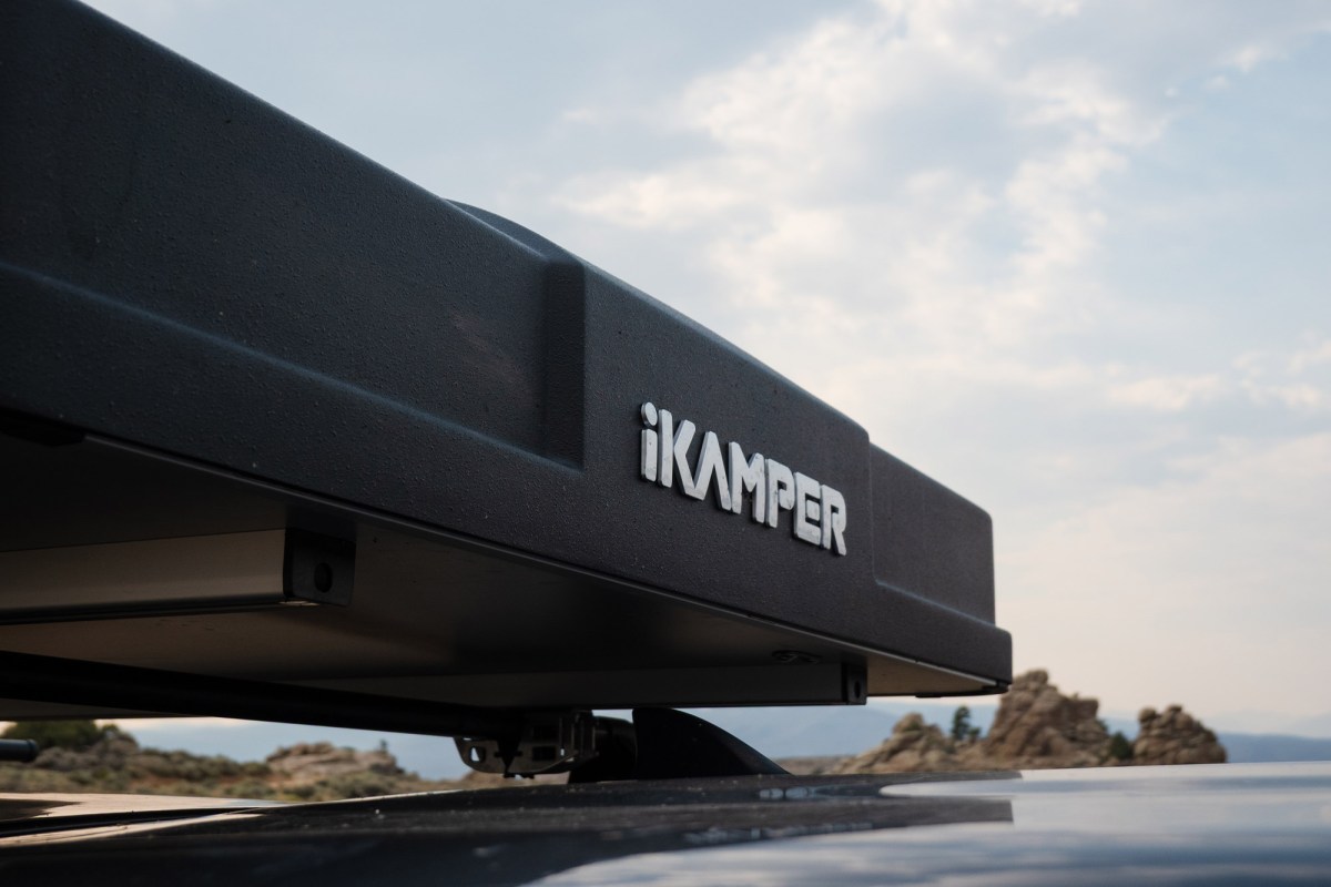 Close-up of the iKamper logo on the closed rooftop camper shell