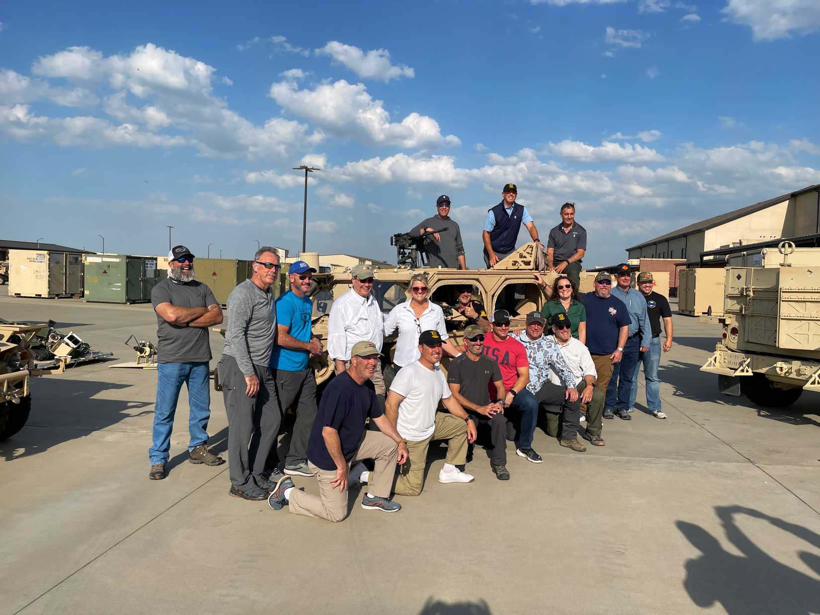 Jodi Burns, CEO of Special Forces Trust, surrounded by several Green Berets and others served by the nonprofit. (SFT).