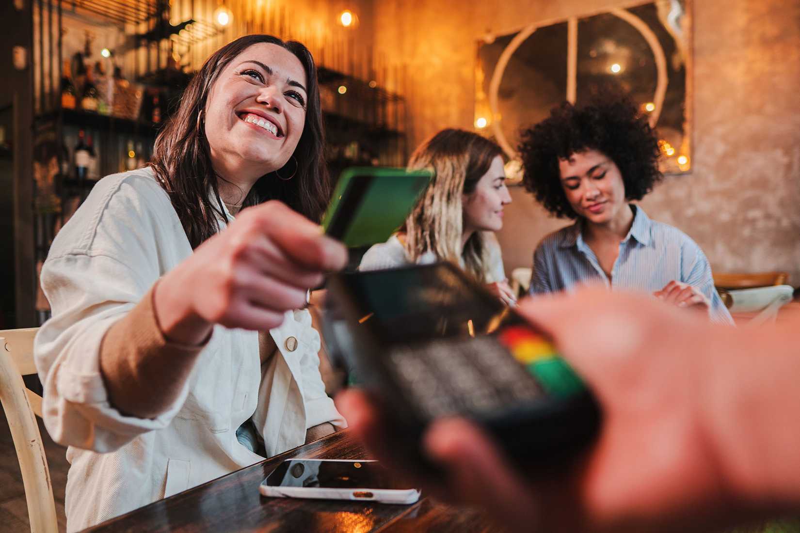 woman paying for dinner with credit card