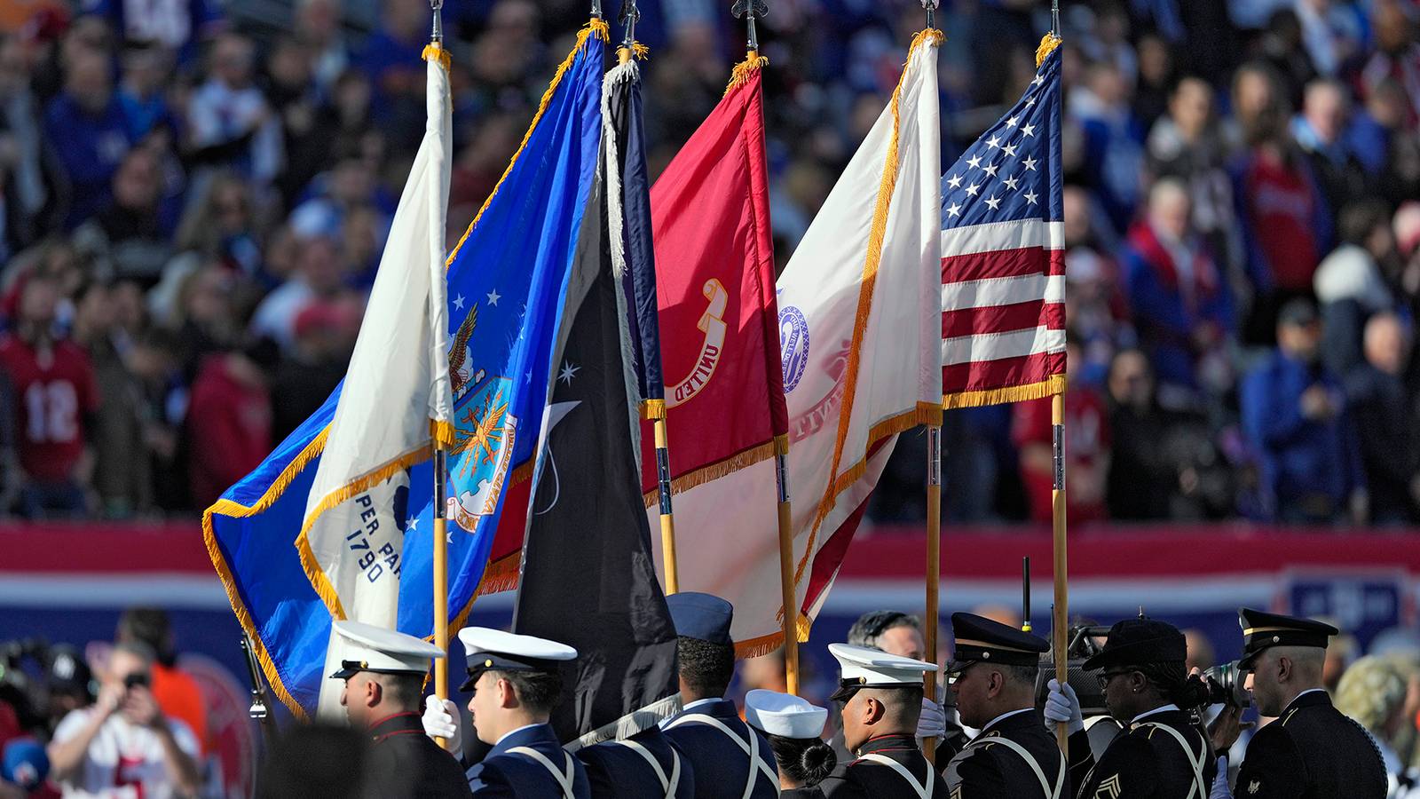 Members of the Armed Forces stand on the field before an NFL game between the New York Giants and the Tampa Bay Buccaneers in East Rutherford, N.J.