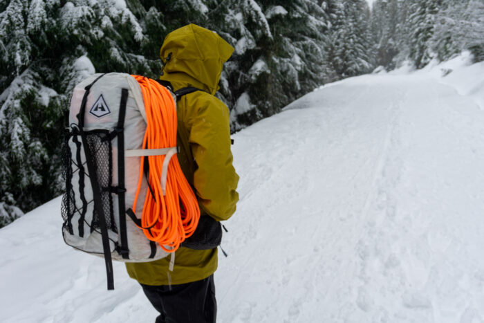 a gearjunkie tester wearing the arc'teryx beta ar hardshell and a hyperlight mountain gear pack 