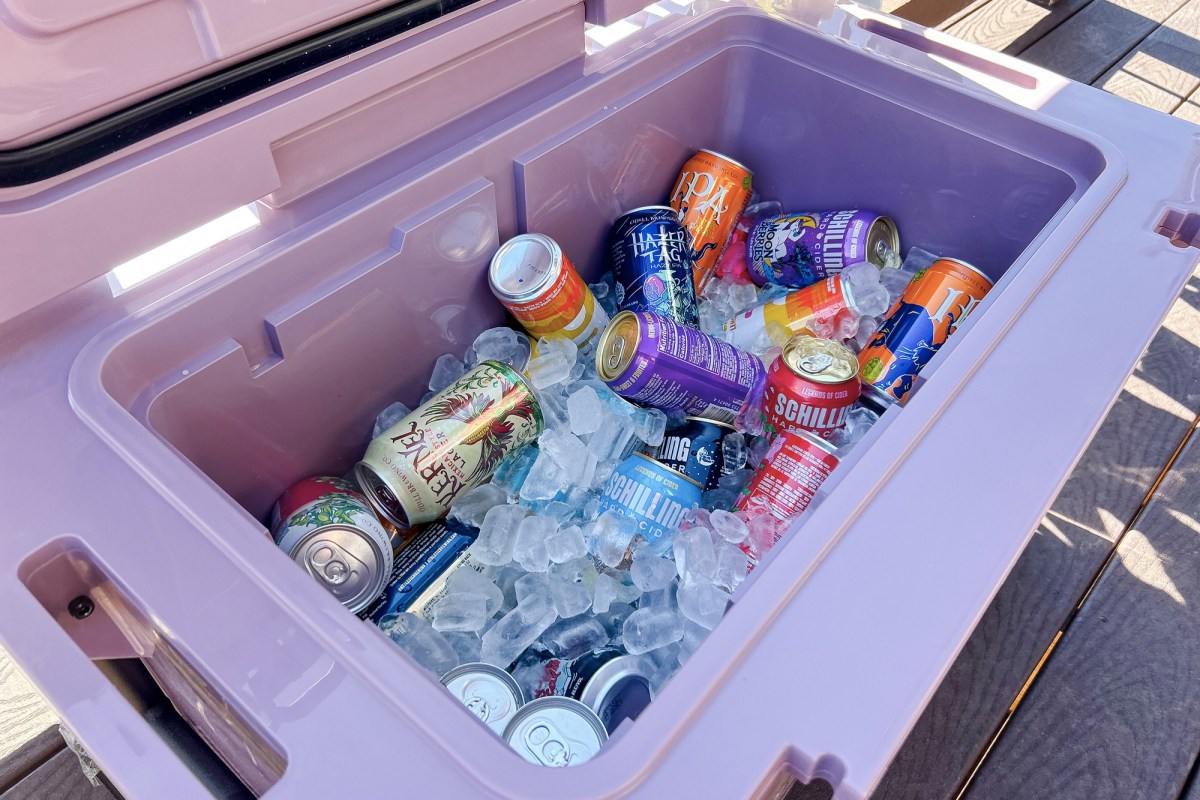 Open 55-quart cooler packed with canned drinks and ice