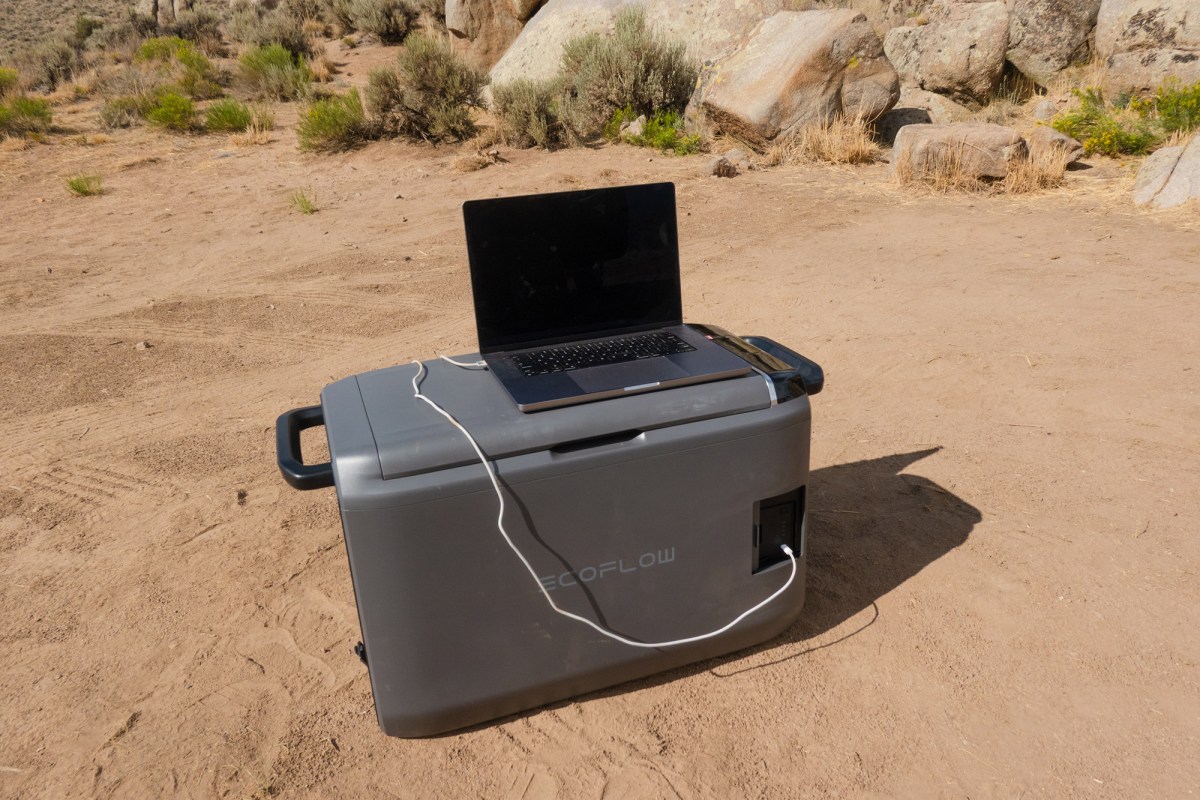 Laptop charging from the GLACIER Classic 45L battery at camp