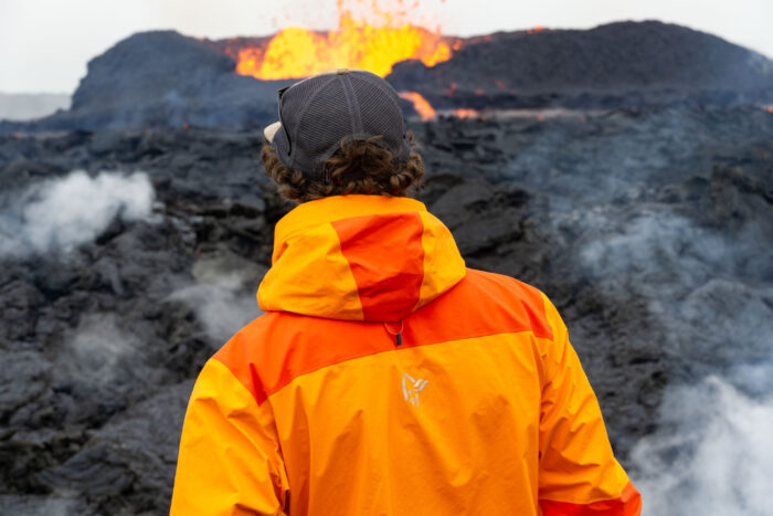 a gearjunkie tester wearing the Norrøna Trollveggen In Front of Iceland Volcano while erupting
